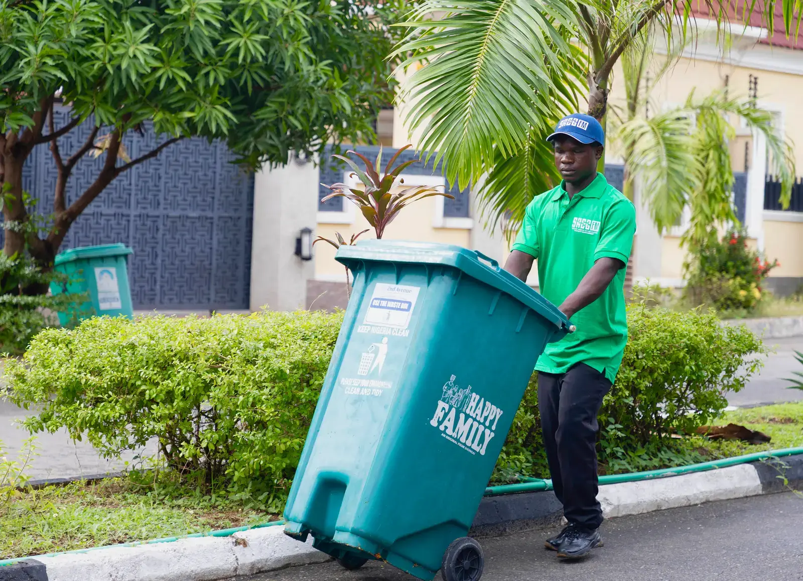 SAEG FM waste-management staff collecting estate refuse in Abuja